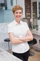 Confident hairdresser smiling at camera