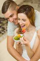 Couple eating fruit salad at breakfast
