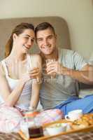 Cute couple having breakfast in bed