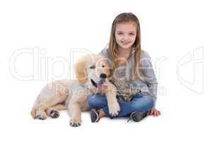 Cute little girl sitting with her dog
