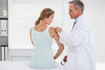 Doctor examining a patients shoulder