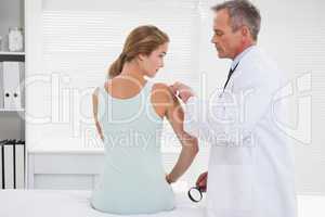 Doctor examining a patients shoulder