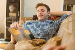 Young man reading on his couch