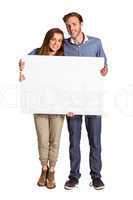 Full length portrait of couple with blank board
