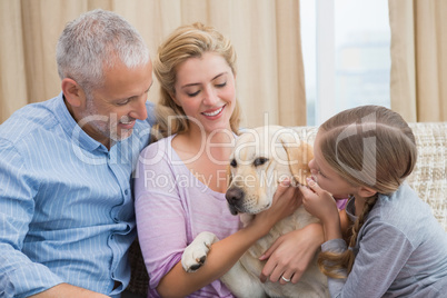 Parents and daughter with pet labrador