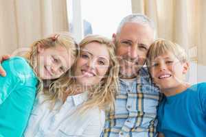 Happy family sitting on couch together