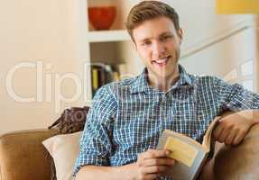 Young man reading on his couch