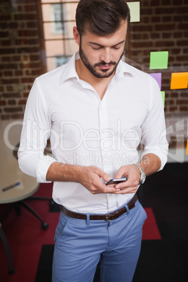 Casual businessman texting on the phone