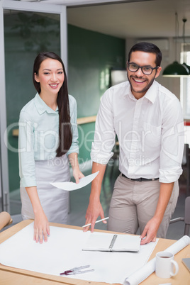 Casual architecture team working together at desk