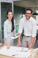 Casual architecture team working together at desk