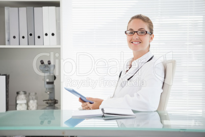 Smiling doctor using her tablet