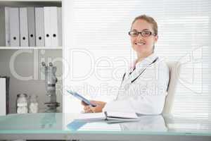 Smiling doctor using her tablet