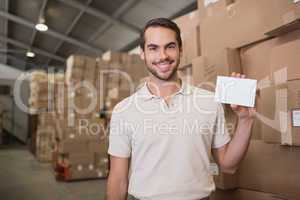 Warehouse worker holding blank paper