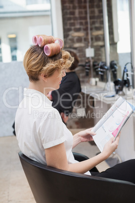 Customer sitting with curlers in hair