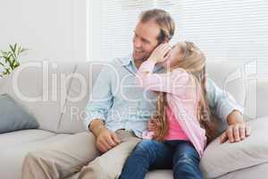 Casual father and daughter on the couch