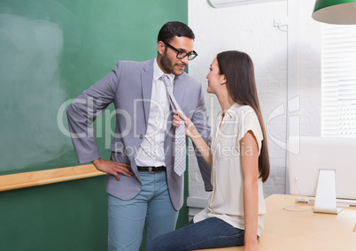 Businessman and woman looking at each other in office