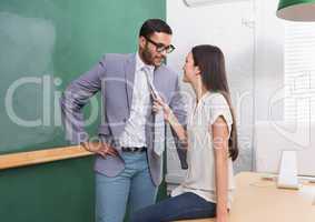 Businessman and woman looking at each other in office
