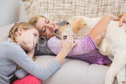 Mother and daughter with pet labrador