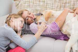 Mother and daughter with pet labrador