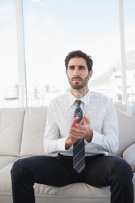 Businessman clapping while sitting down