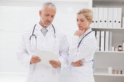 Concentrated doctors coworker analyzing results