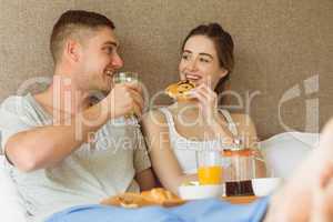 Cute couple having breakfast in bed