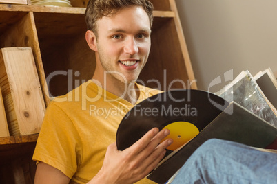 Young man looking at his vinyl collection