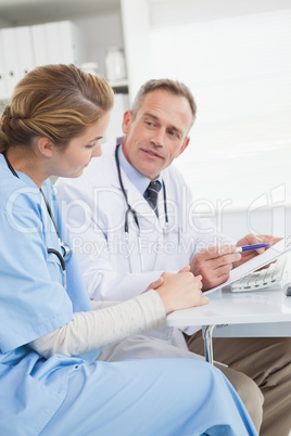 Doctor and nurse looking at a computer