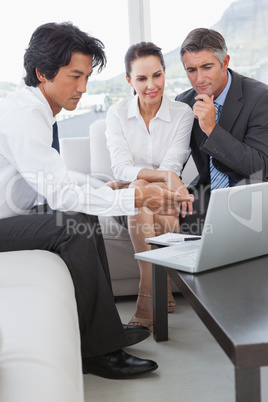 Business team looking at a laptop