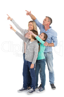 Happy family smiling and pointing at something