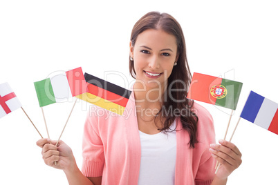Pretty brunette smiling and holding flags
