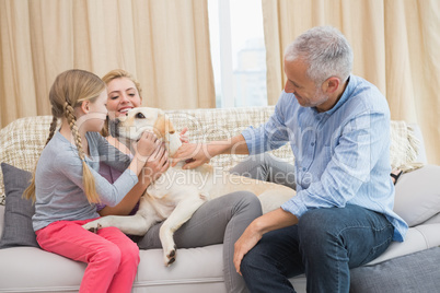 Parents and daughter with pet labrador
