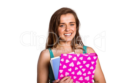 Smiling young woman with books