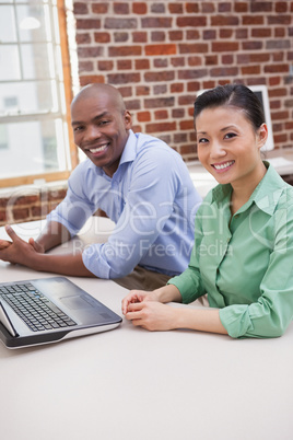 Casual business team working together at desk