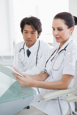 Focused doctors reviewing notes