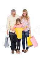 Parents and daughter with shopping bags