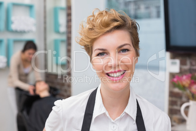 Confident hairdresser smiling at camera