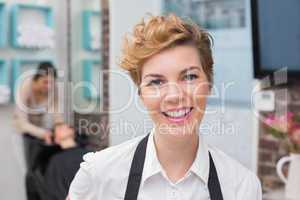 Confident hairdresser smiling at camera