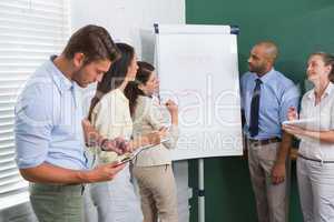 Businesswoman presenting to the team taking notes