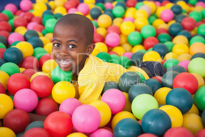 Cute boy smiling in ball pool