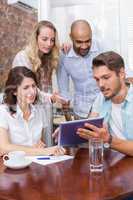 Businesswoman pointing tablet pc in meeting