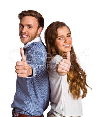 Happy young couple gesturing thumbs up