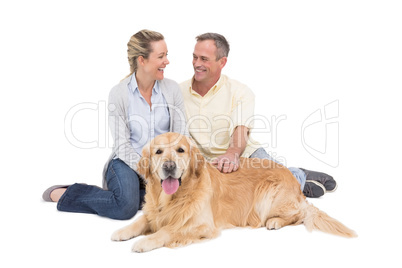 Portrait of smiling couple sitting together with their dog