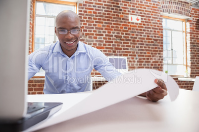 Casual businessman using his laptop at desk