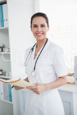 Happy doctor holding a medical file