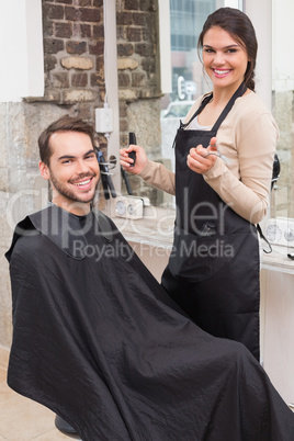 Handsome man getting his hair trimmed