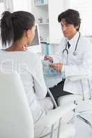 Doctor taking notes from patient
