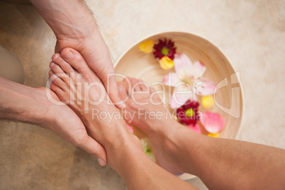 Pedicurist washing a customers feet