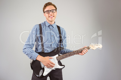 Geeky hipster playing the guitar