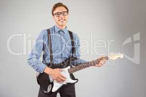 Geeky hipster playing the guitar